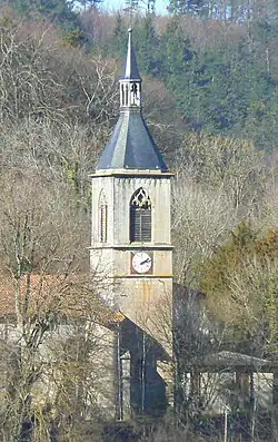Clocher rectangulaire avec une flèche de charpente double, en ardoise munie d'un clocheton.