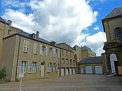 L'officialité (porte de gauche), les pèlerinages diocésains (porte au centre) et l'entrée de l'abbatiale (à droite).