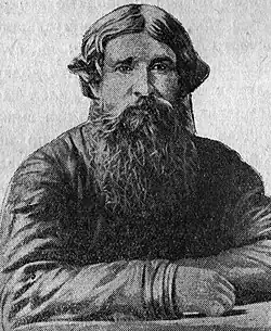 Reproduction d'une photographie d'homme. Cheveux et barbe longs. Visage rond et doux