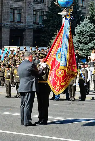 Vladyslav Klotchkov, chef de corps de la 93e&nbsp;brigade recevant le drapeau de bataille du Président Petro Porochenko.