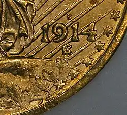 Détail d'une pièce de monnaie. La date, six étoiles, la lettre « S » au-dessus de la date et « SG » entrelacés en-dessous.