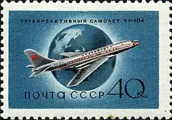 timbre bleu, représentant un Tu-104 posé devant un globe terrestre.