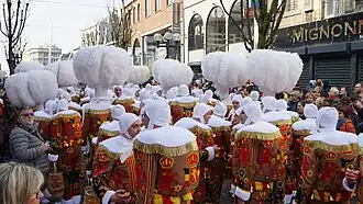 Les Gilles dans la rue Albert 1er, avec leurs chapeaux à plumes.