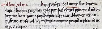 Un morceau d'une page de parchemin portant une indication d'année à l'encre rouge suivie d'un texte en vieil anglais à l'encre noire