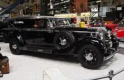 Image d'un cabriolet Mercedes noir classique avec le toit fermé dans un musée