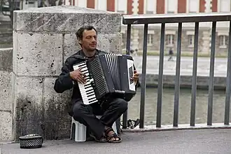 Accordéoniste jouant sur un pont à Paris