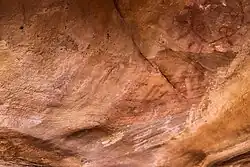 Dessin géométrique en rouge, avec des rayons, et des mains positives et négatives