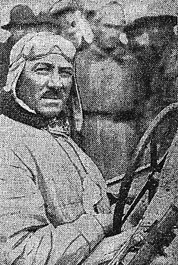 Photo d'André Morel posant au volant de sa voiture.