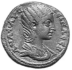 pièce de monnaie représentant une femme de profil en buste, entourée d'inscriptions.