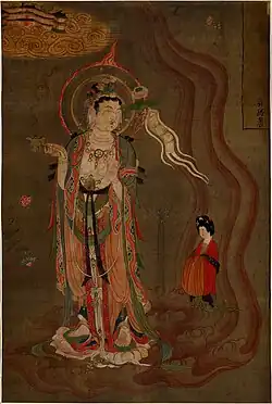 Bodhisattva montrant la voie, couleurs sur soie, 80,5&nbsp;×&nbsp;53,8&nbsp;cm. Trouvé à Dunhuang (grotte 17). Le bodhisattva montre le chemin à une femme qui tient un brûle parfum dans sa droite et dans sa gauche une fleur de lotus. British Museum.