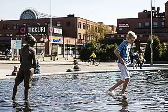 Le bassin construit en 2016 devant la mairie. Au fond, le centre commercial Tikkuri.