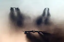 Trois B-52 décollent, en laissant derrière eux d'immenses nuages de fumée noire.