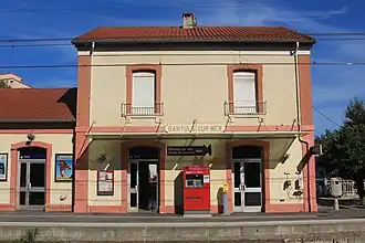 Bâtiment voyageurs côtés voies, avec automate de billets TER et téléphones de service.