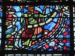 Photo d'un détail de la baie 9 où se trouve un phylactère avec l'inscription « Clemens vitrearius Carnotensis me fecit »