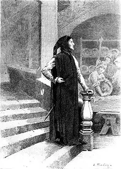 Un homme de profil vêtu de noir au bas d'un escalier regarde vers le lointain, l'air inspiré.