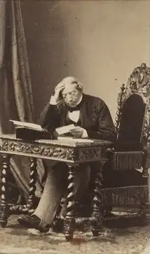 Représentation du baron James de Rothschild, assis à un bureau et consultant un document