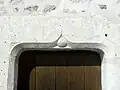 Nef, linteau du portail latéral sud.