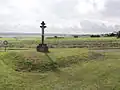 Une croix au lieu-dit de la Pouyade. Au second plan, des terres agricoles.