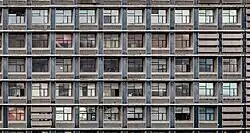 Façade de 10 x 5 petites fenêtres de petits appartements.