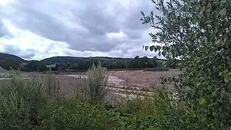 Carrière de Foufouilloux en exploitation par Imérys (partie Sud-Ouest). Au fond, hameau de Foufouilloux.