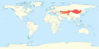 Carte mondiale montrant en rouge l'aire d'élevage du Chameau de Bactriane qui s'étend de la Turquie à la Chine.