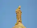 Statue du Sacré-Cœur de Jésus au sommet du clocher.