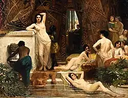 Peinture en couleurs représentant un groupe de femmes voilées et nues autour d'un bassin d'eau entouré par quelques personnages habillés, dans un décor opulent.