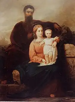 Tableau dépeignant un couple formé d'un homme barbu, qui est vêtu d'une tunique brune foncée, et d'une femme qui porte une tunique claire avec une couverture bleue. Sur les genoux de la mère se tient debout un enfant qui porte une tunique blanche.