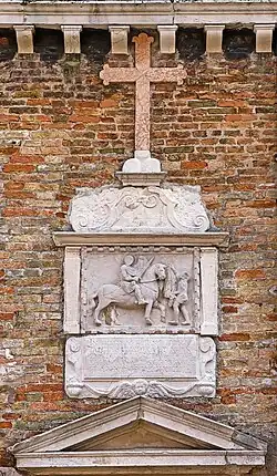 Bas-relief représentant le saint,  au-dessus de l'entrée de l’oratoire sur la façade principale (XVe&nbsp;siècle).