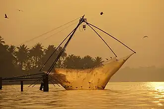 Un carrelet chinois abaissé sur le lac Ashtamudi, au lever du jour dans la région de Quilon.