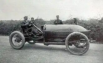 Photo d'un conducteur et de son mécanicien embarqué, prenant la pause au volant de leur véhicule.