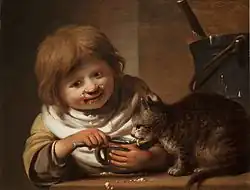 Garçon donnant de la nourriture à un chat