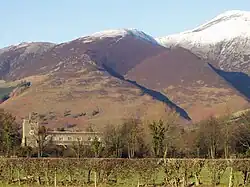 Old village church with a backdrop of snow-capped fells