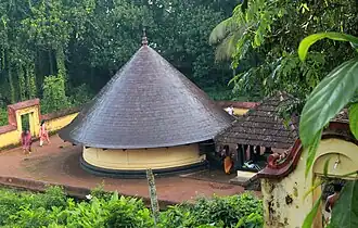 Le petit temple de Shiva à Kaviyoor. Xe&nbsp;siècle. Le sanctuaire circulaire, à gauche, ouvert aux 4 orients, est séparé du mandapa, sur plan carré, à droite.