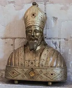 Photographie de face d'un objet en bois doré.