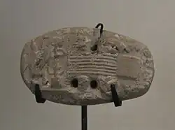 Tablette de comptabilité avec empreinte de sceau représentant une scène de tissage. Musée du Louvre.