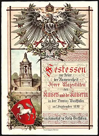 Première page du menu pour le banquet en l'honneur de la présence de Guillaume II (empereur allemand) et de Augusta-Victoria de Schleswig-Holstein-Sonderbourg-Augustenbourg à l'Hotel Kaiserhof (Porta Westfalica)&nbsp;(de) le 7 septembre 1898. Taille : 26&nbsp;cm x 19&nbsp;cm.