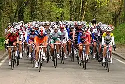 Photo d'un peloton cycliste sur une route.