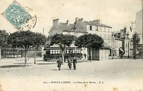 Tramway à l'arrêt devant l'église d'Épinay, devant son aubette.