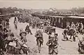 Débarquement de troupes se rendant au camp de Coëquidan en gare de Guer (carte postale, 1914).
