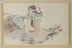 Un homme et une femme enlacés, à demi-vêtus, sur un futon