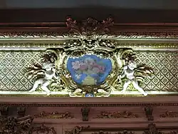 Cartouche néo-baroque avec peinture florale au plafond.