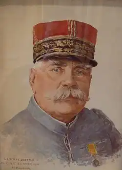 Portrait d'un homme moustachu et un képi rouge.