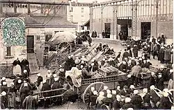 Photographie du marché aux volailles sur la place du marché avec les anciennes halles de l'ingénieur Michelin détruite en 1976