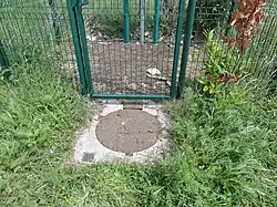 La tête de puits matérialisée.