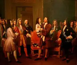 Le tsar, debout, tient l'enfant de sept ans dans ses bras. Derrière eux, deux fauteuils. Tout autour, des grands seigneurs et un ecclésiastique.