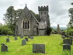 Exterior of 19th century neo-gothic church surrounded by a country churchyard