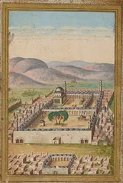 Miniature représentant le sanctuaire de Médine avec des habitations au premier plan, et des montagnes et le ciel bleu nuageux en arrière-plan.