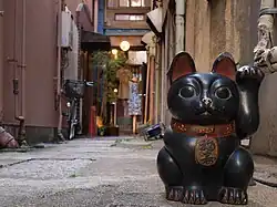 Un Maneki-neko noir dans une rue d'Asakusa (Tokyo).
