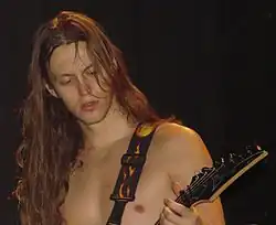 Image d'un homme torse-nu jouant de la guitare